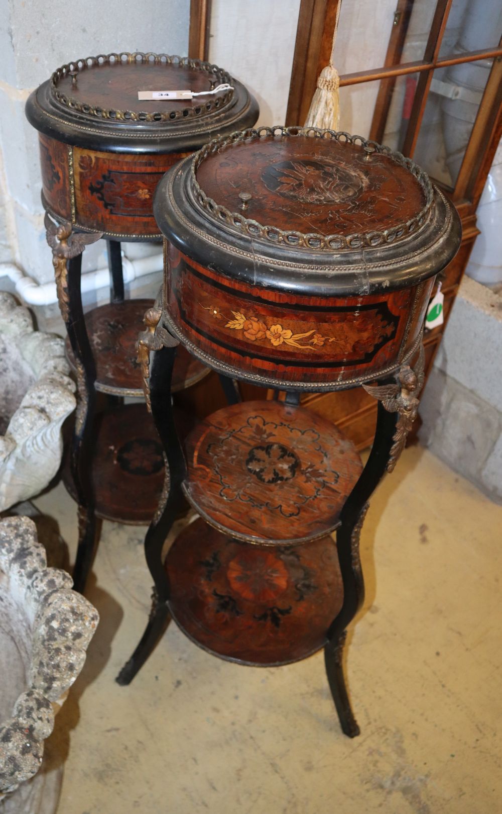 A pair of French marquetry three tier jardiniere tables, 34cm diameter, H.101cm